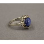 A 14 K white gold and star sapphire ring. Ring Size N.