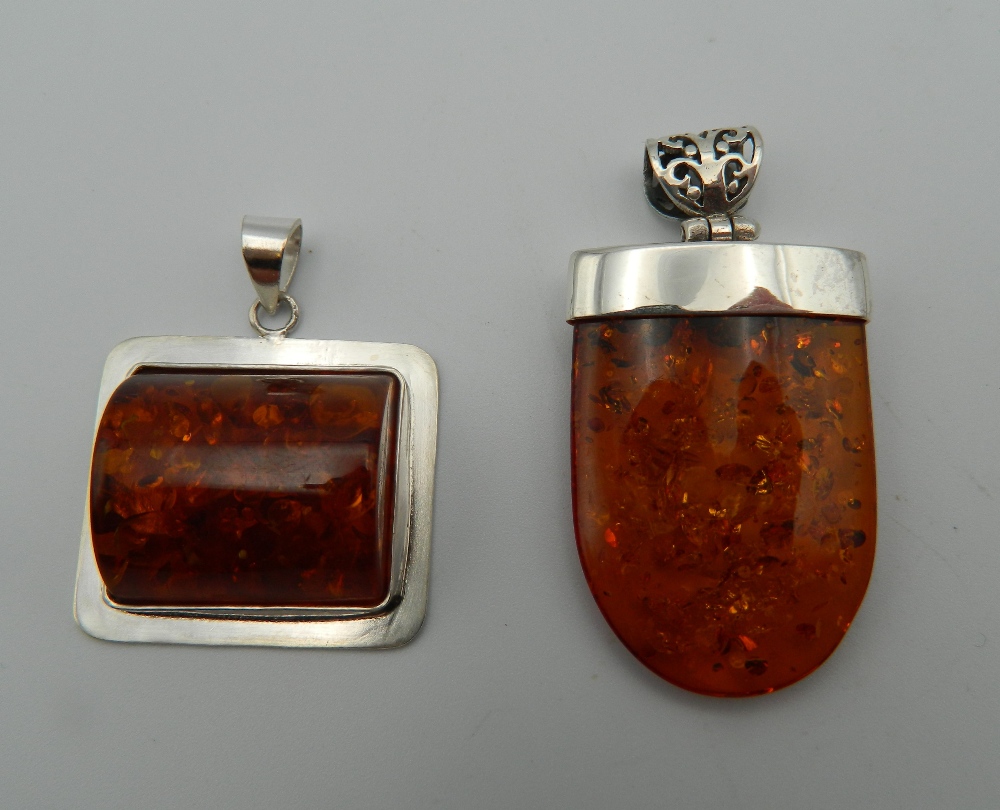 Two silver dress pendants. The largest 5 cm high.