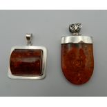 Two silver dress pendants. The largest 5 cm high.