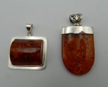 Two silver dress pendants. The largest 5 cm high.