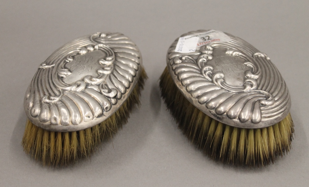 Two silver brushes. Each 13 cm long.