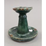 A Persian pottery candlestick. 9 cm high.