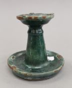 A Persian pottery candlestick. 9 cm high.