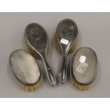 Two silver brushes,