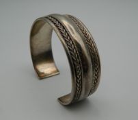 A silver bangle. 6.5 cm wide. 40.9 grammes.