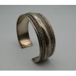 A silver bangle. 6.5 cm wide. 40.9 grammes.