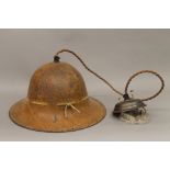 A Belgian military helmet, converted to a hanging lamp. 29 cm wide.