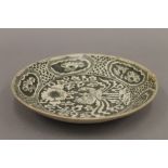 An antique Oriental pottery dish. 25.5 cm diameter.