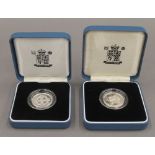 Two solid silver boxed £1 coins with certificates.
