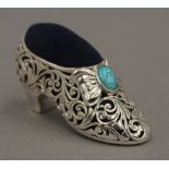 A silver shoe pin cushion set with an opal. 5 cm wide.