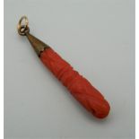 An Edwardian carved coral and gold pendant. 3 cm high.