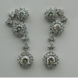 A pair of 18 K white gold diamond drop earrings, the drops each set with a 0.5 carat diamond.