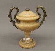 A gilt metal mounted twin handled urn. 29 cm high.