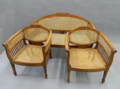 An early 20th century caned three piece suite. The settee 126 cm wide.