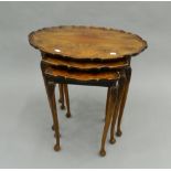 A nest of three mahogany tables. 61 cm wide.
