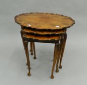 A nest of three mahogany tables. 61 cm wide.