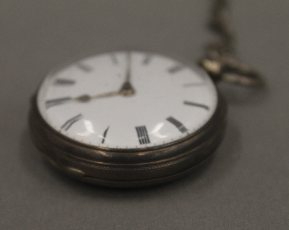 Two 19th century silver pocket watches on chains and a brass pocket watch case. - Image 8 of 12