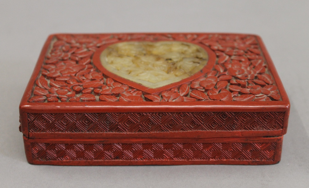 A cinnabar and jade box. 14.5 cm wide.