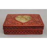 A cinnabar and jade box. 14.5 cm wide.