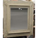 A large decorative white framed mirror. 84 cm wide.