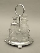 An early 20th century cut glass and silver plated cruet stand. 21 cm high.