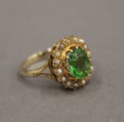 A 9 ct gold peridot and seed pearl ring. Ring size N.