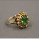 A 9 ct gold peridot and seed pearl ring. Ring size N.