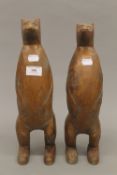 Two carved wooden meerkats. The largest 36 cm high.