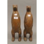 Two carved wooden meerkats. The largest 36 cm high.