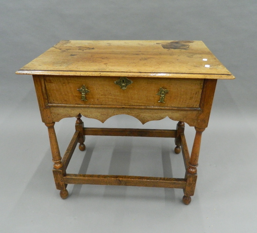 An 18th century style walnut side table. 79 cm wide.