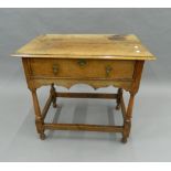 An 18th century style walnut side table. 79 cm wide.