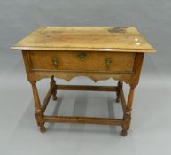 An 18th century style walnut side table. 79 cm wide.