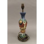 A Moorcroft Anna Lily table lamp by Nicola Slaney with matching silk shade.