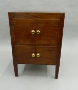 A Georgian mahogany pot cupboard. 54.5 cm wide, 45.5 cm deep, 76 cm high.