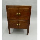 A Georgian mahogany pot cupboard. 54.5 cm wide, 45.5 cm deep, 76 cm high.