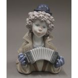 A Lladro bust of a clown playing an accordion. 17 cm high.