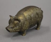 A brass model of a pig. 9 cm long.