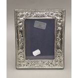 A silver photograph frame, hallmarked London 1968. 20 cm high.