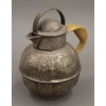 An engraved white metal Jersey jug. 14 cm high.