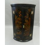 An 18th century chinoiserie lacquered hanging corner cupboard. 97 cm high.