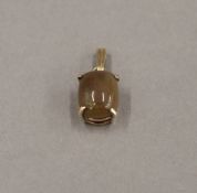 A 9 ct gold opal pendant. 1.5 cm high. 1.5 grammes total weight.