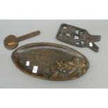 An antique wooden oval shaped tray with carved vine decoration and a small antique carved African