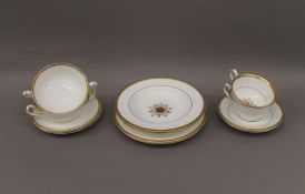 A quantity of gilt decorated Crown Derby dinner wares