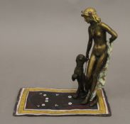 A cold painted bronze model of a girl and leopard. 16 cm high.