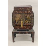An early 20th century Japanese lacquered table cabinet, on stand. 52 cm high.