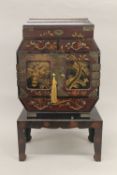 An early 20th century Japanese lacquered table cabinet, on stand. 52 cm high.