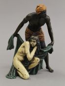 A cold painted bronze model of an Arab and nude. 14 cm high.