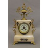 A cloisonne decorated alabaster three-piece clock garniture. The clock 42 cm high.