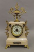 A cloisonne decorated alabaster three-piece clock garniture. The clock 42 cm high.