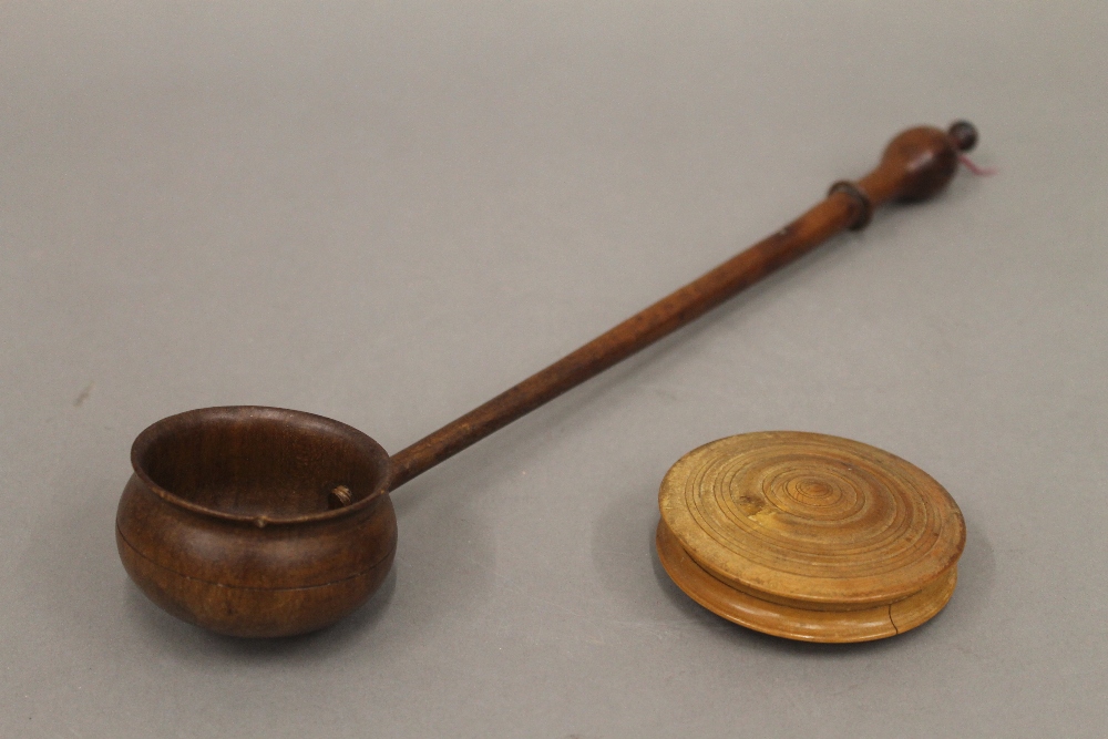 A treen box and ladle. The latter 33.5 cm long.